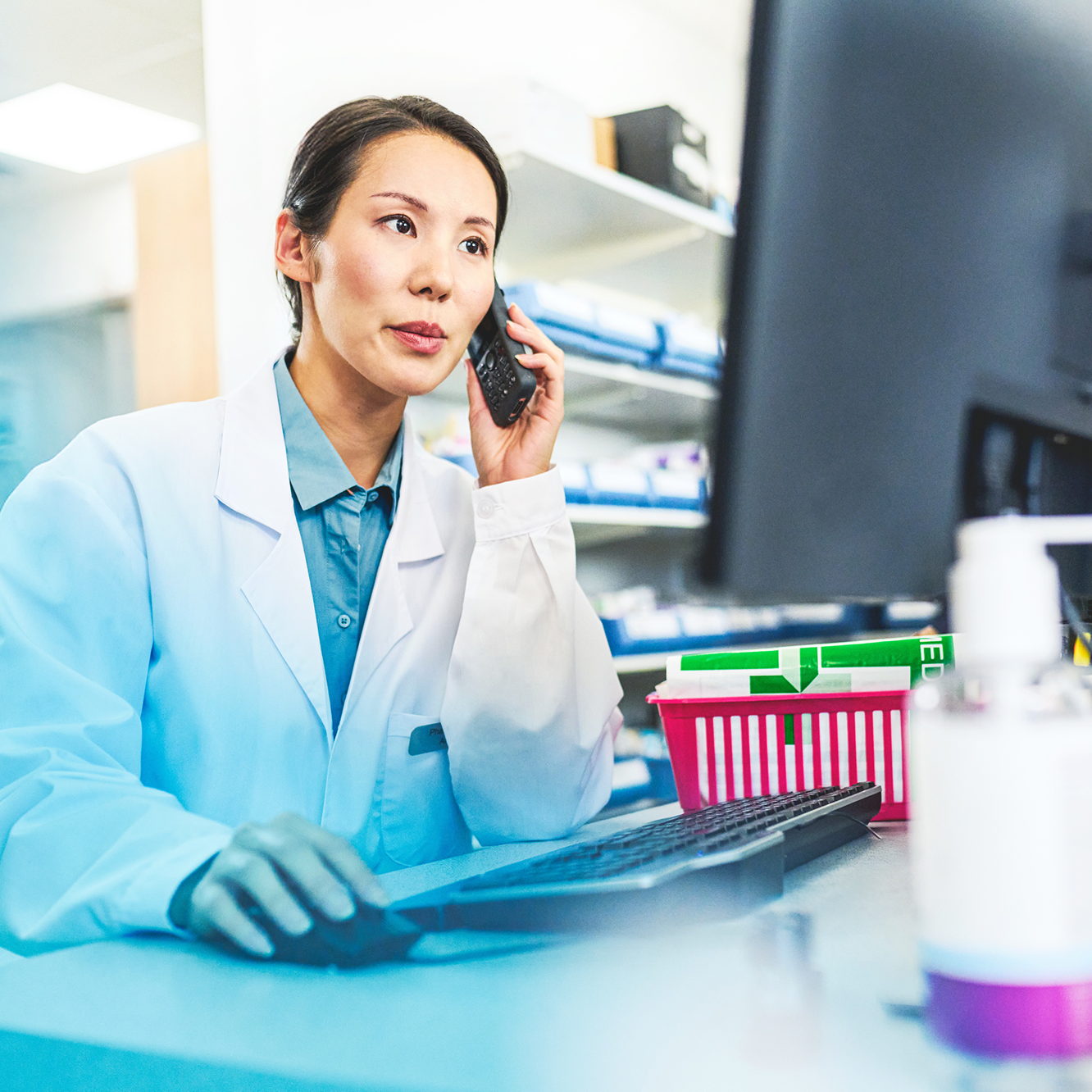 Pharmacist working in front of a monitor